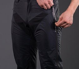 zipping up a pocket in waterproof trousers